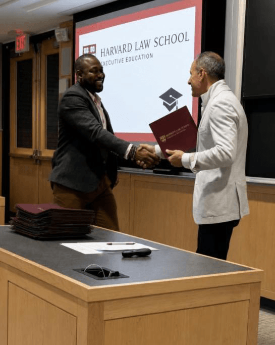 Dr. Charles Osuji receiving a Harvard Law School program credential